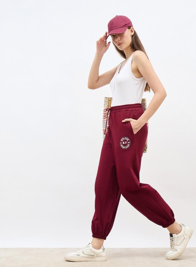 Burgundy Tapered Joggers With Graphic Print