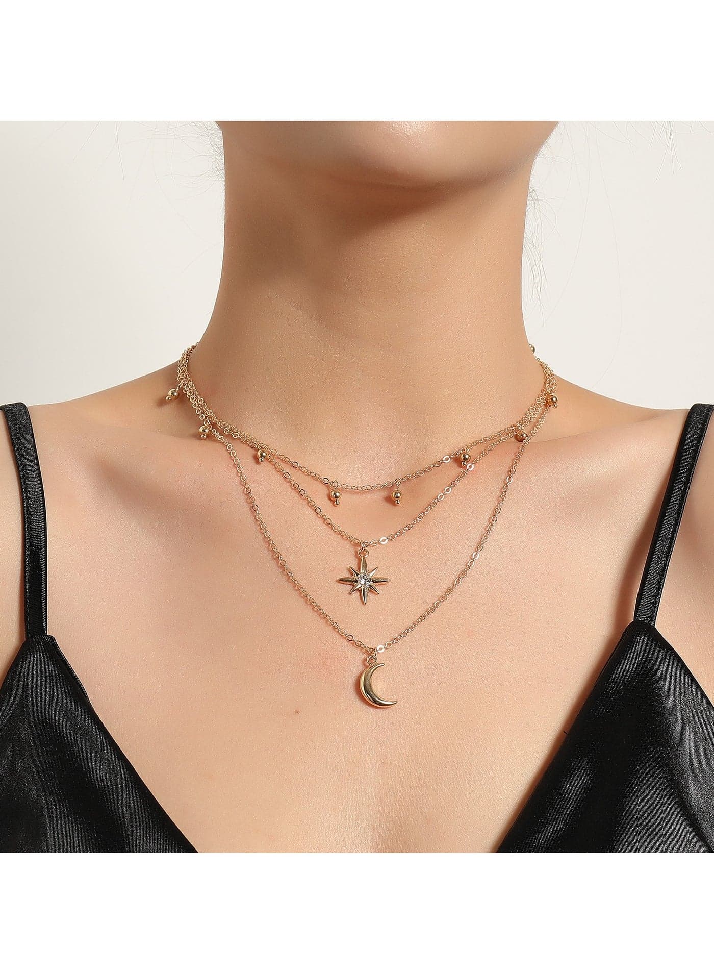 Trendy Gold Toned Layered Choker Necklace Set, Crafted from Durable Metal Chains, Adorned with Delicate Star and Moon Pendants along with Shiny Gold Beads. Ideal for Daily Outfits, Parties, and Any