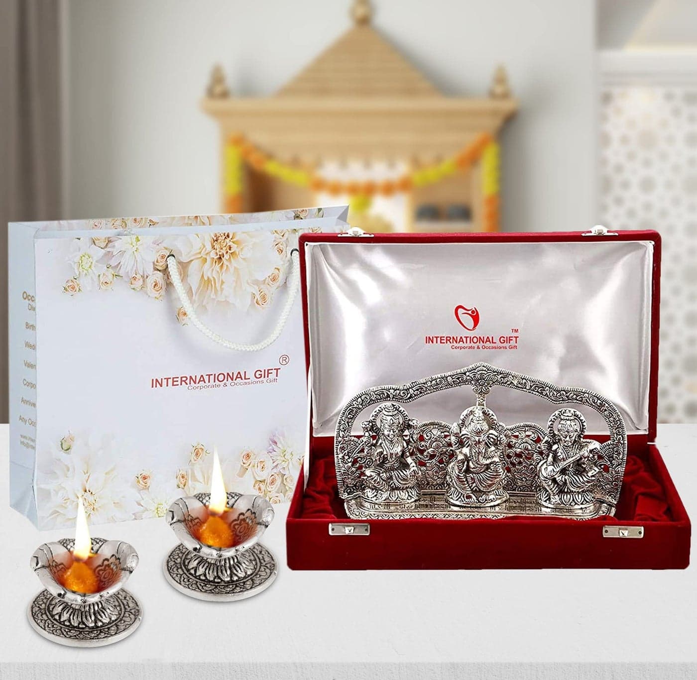 INTERNATIONAL GIFT® Silver Plated Laxmi Ganesh Saraswati GodIdol Statue Oxidized Finish with 2 Piece Hand Diya with Beautiful Velvet Box Packing and with Carry Bag (14H x 25W x 5L Centimeters), Idol