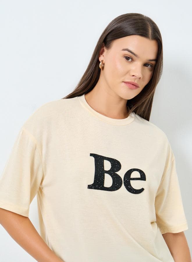 Styli Beige Oversized Embellished Slogan T-Shirt