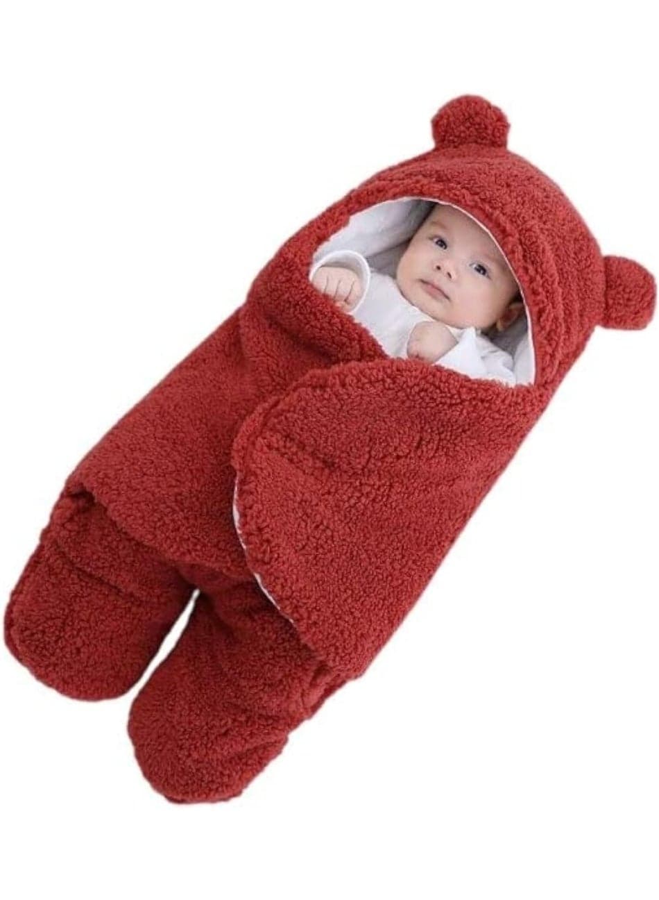 A serene baby moment featuring a little one in a fluffy red swaddle with adorable ears, lying quietly with a soft toy, showcasing warmth, security, and the beauty of gentle rest.